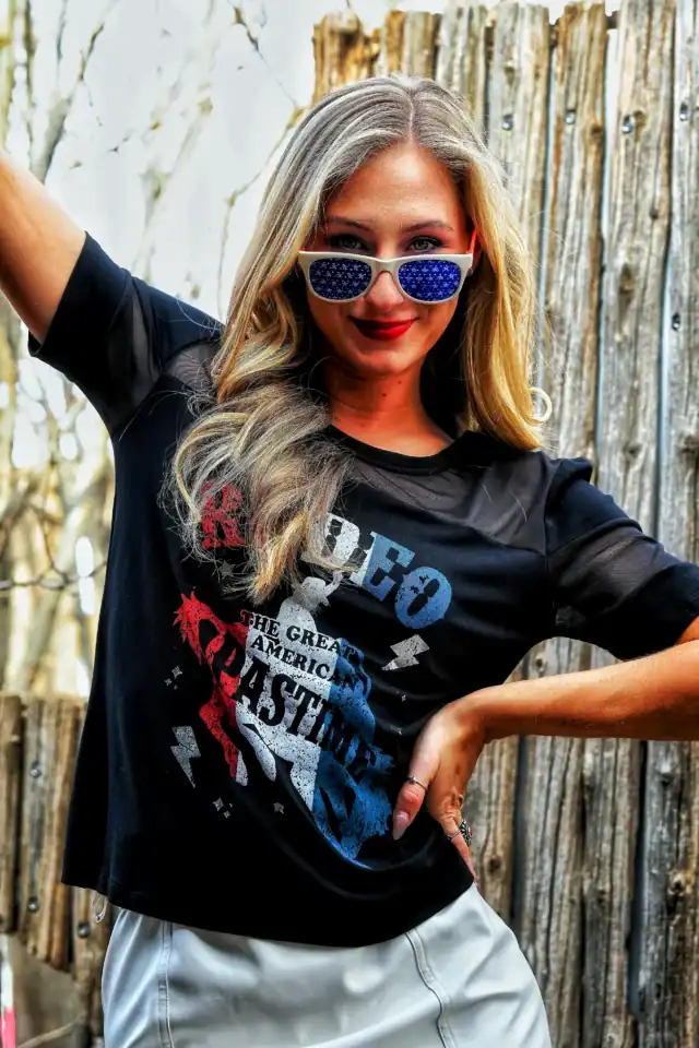 A woman wearing sunglasses and a Rodeo t-shirt from Liberty Wear Apparel.