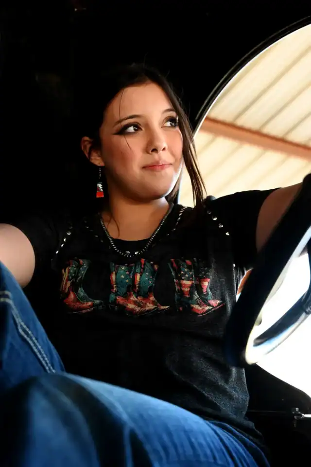A woman sitting in the driver's seat of a car